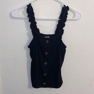 A black tank top with buttons